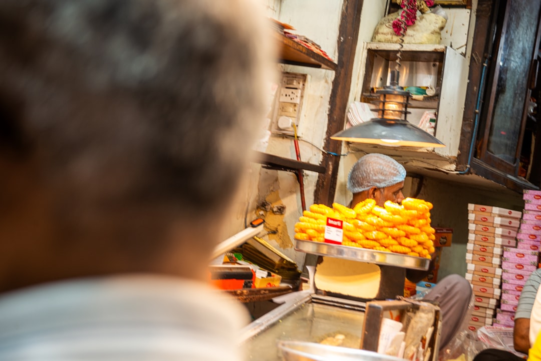 Vendor selling sweets at a market stall